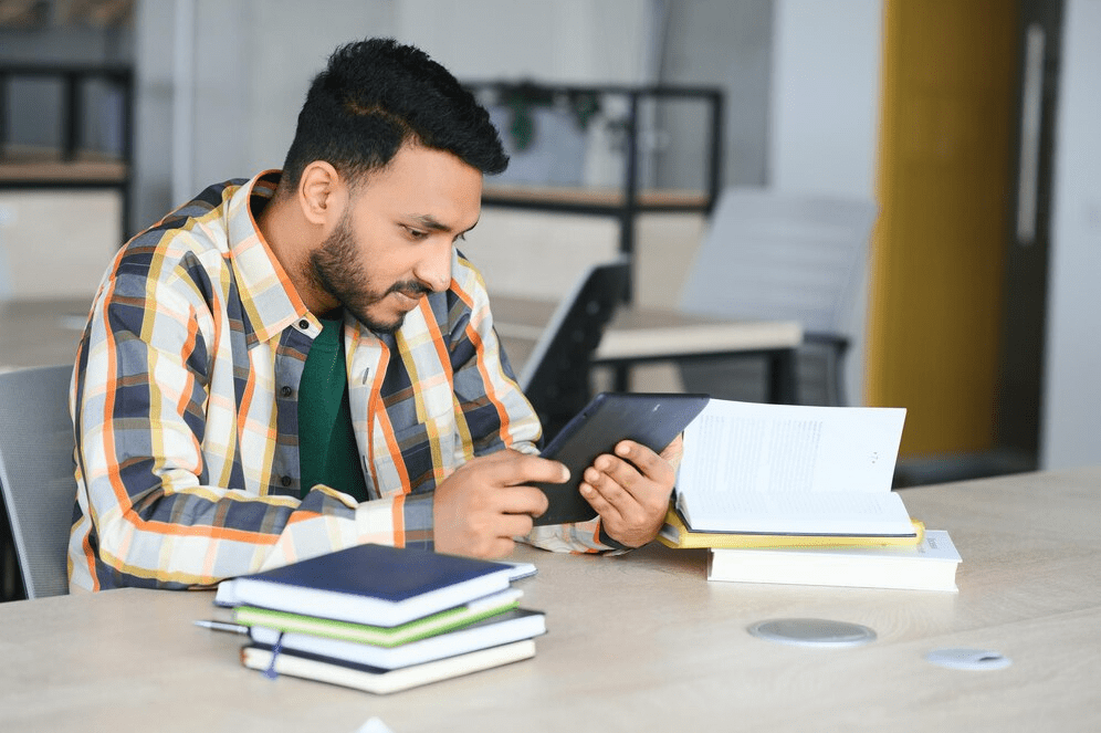 a man looking at a tablet-midlands-consultants
